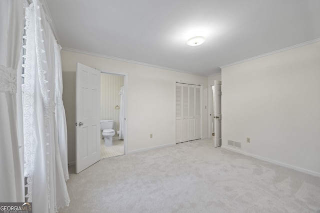 unfurnished bedroom featuring light carpet, connected bathroom, and ornamental molding