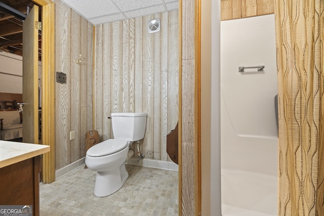 bathroom featuring a paneled ceiling, vanity, and toilet