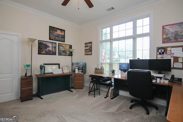 office space featuring ceiling fan, ornamental molding, and light carpet