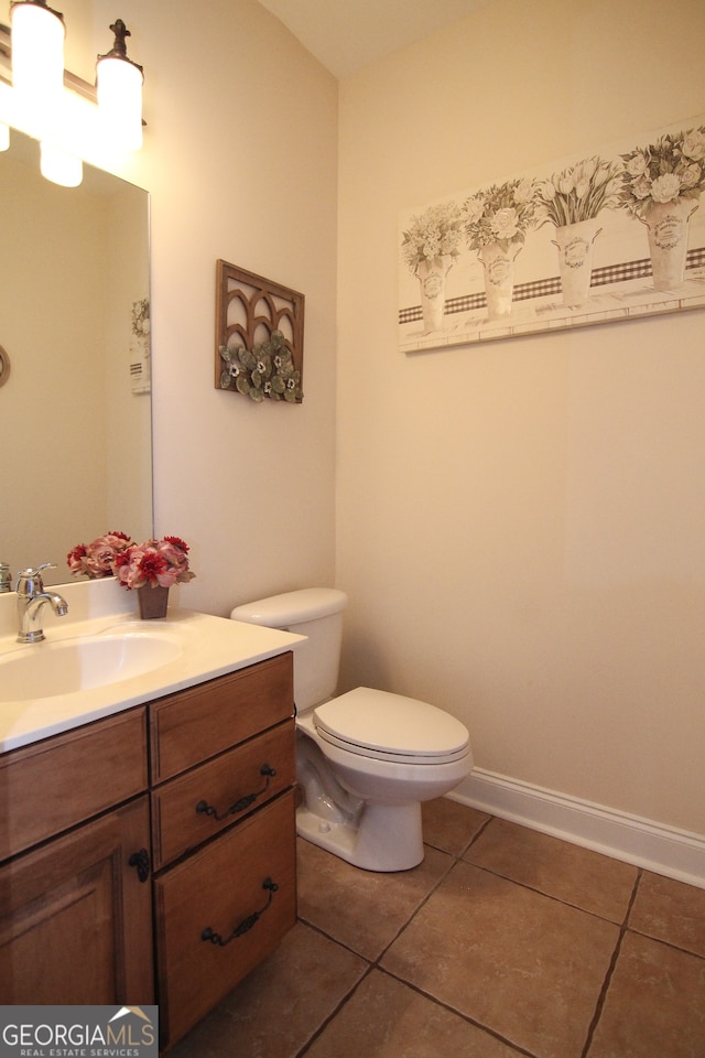 bathroom featuring tile patterned flooring, vanity, and toilet