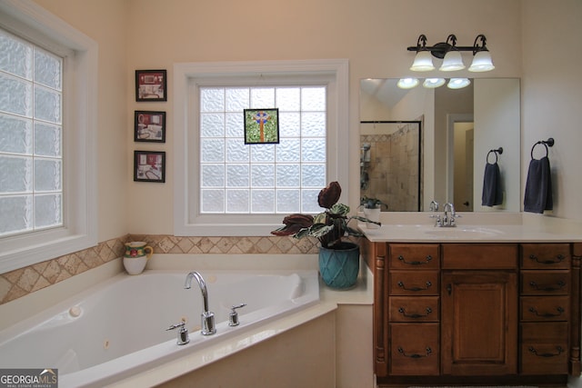 bathroom with shower with separate bathtub and vanity