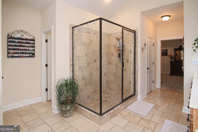 bathroom featuring a shower with door