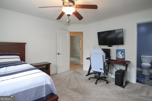 bedroom featuring connected bathroom, ceiling fan, and light colored carpet