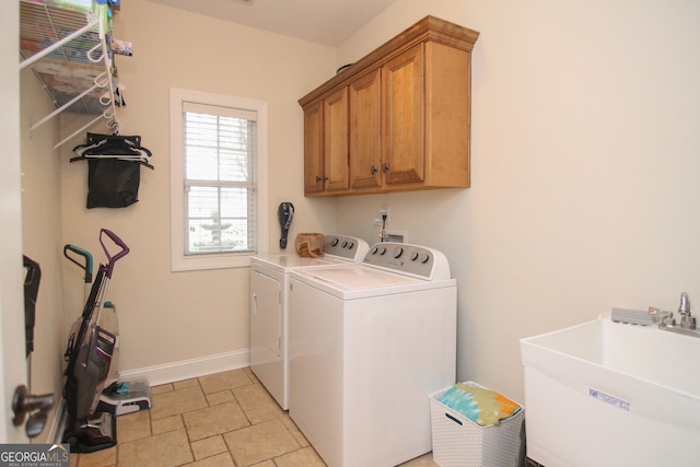 laundry area with washer and clothes dryer, sink, and cabinets