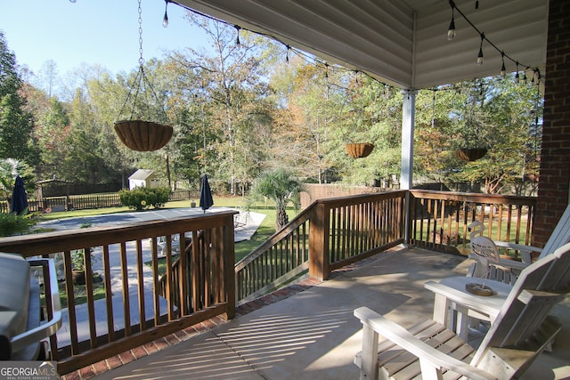 wooden terrace featuring a storage unit