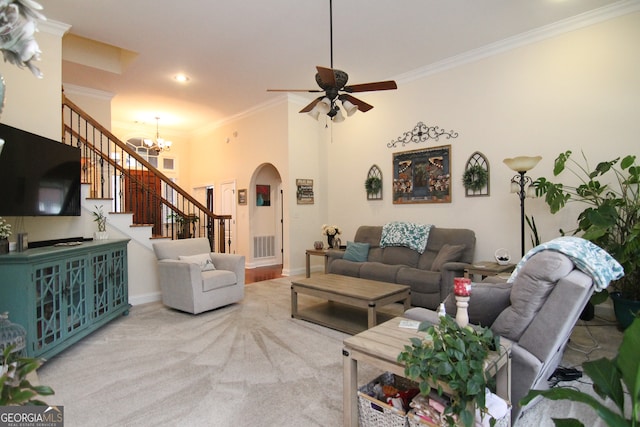 living room with ceiling fan with notable chandelier, carpet floors, and crown molding