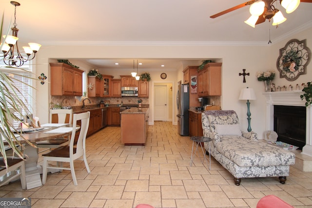 kitchen featuring pendant lighting, backsplash, ceiling fan with notable chandelier, ornamental molding, and appliances with stainless steel finishes