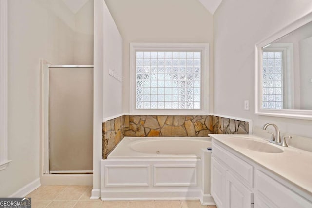 bathroom featuring tile patterned floors, plenty of natural light, lofted ceiling, and vanity