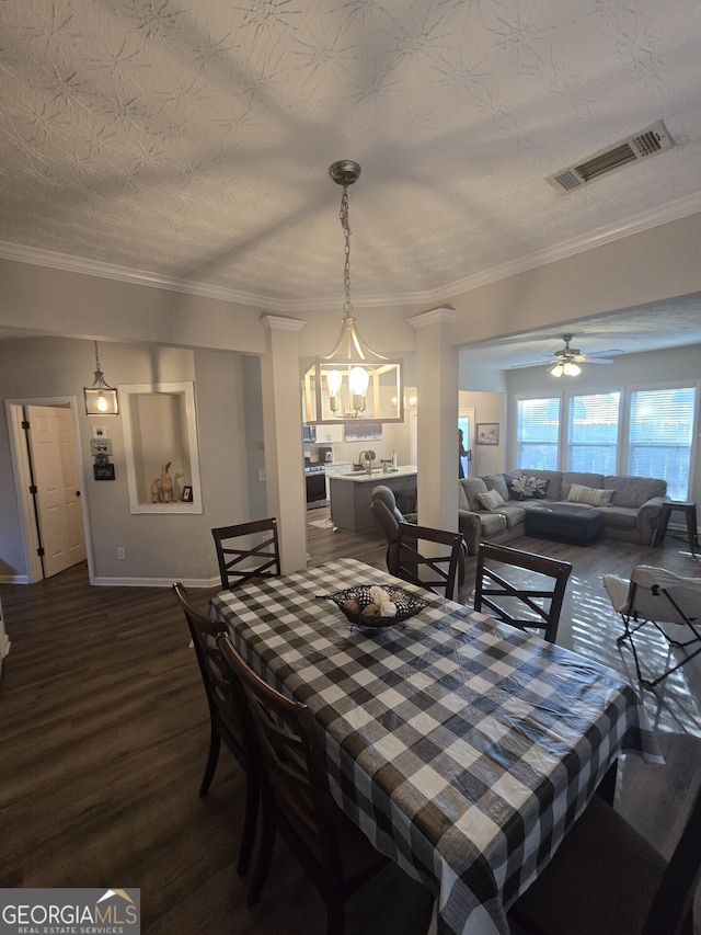 dining space featuring a textured ceiling, crown molding, hardwood / wood-style floors, and ceiling fan with notable chandelier