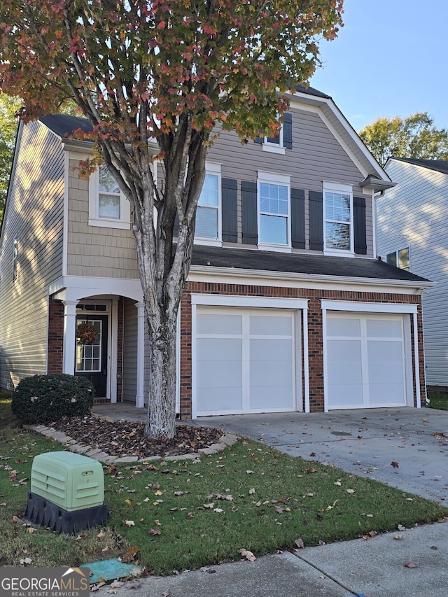 view of property with a front yard and a garage