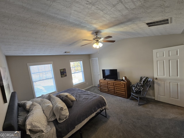 carpeted bedroom with vaulted ceiling, ceiling fan, and a textured ceiling