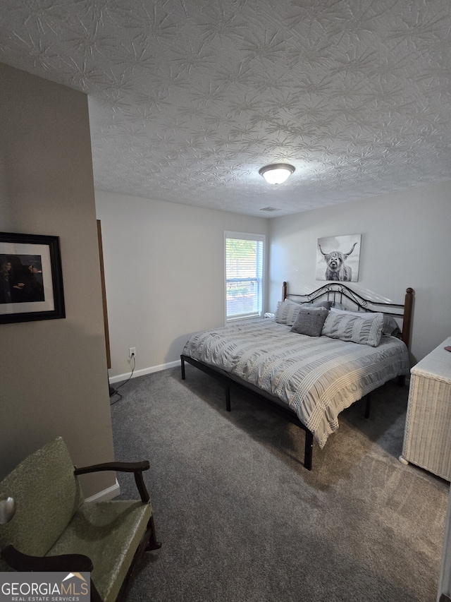 carpeted bedroom featuring a textured ceiling