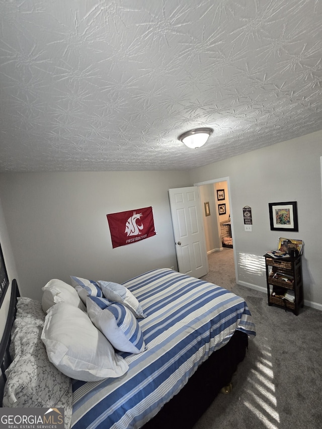 bedroom with carpet and a textured ceiling