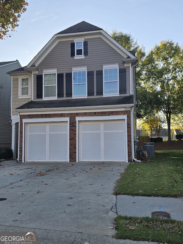 front of property featuring central air condition unit, a front yard, and a garage