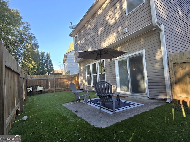 back of property featuring a yard and a patio