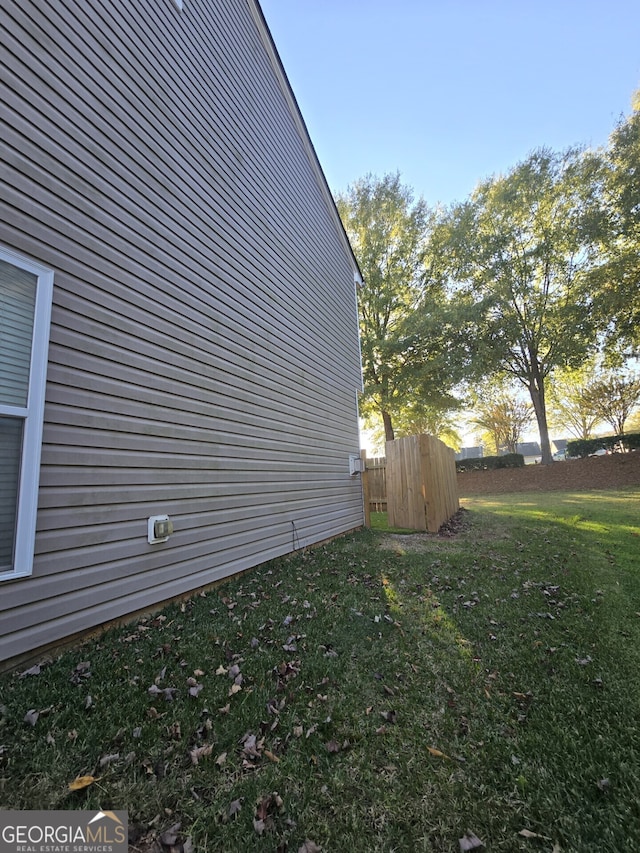 view of home's exterior featuring a yard