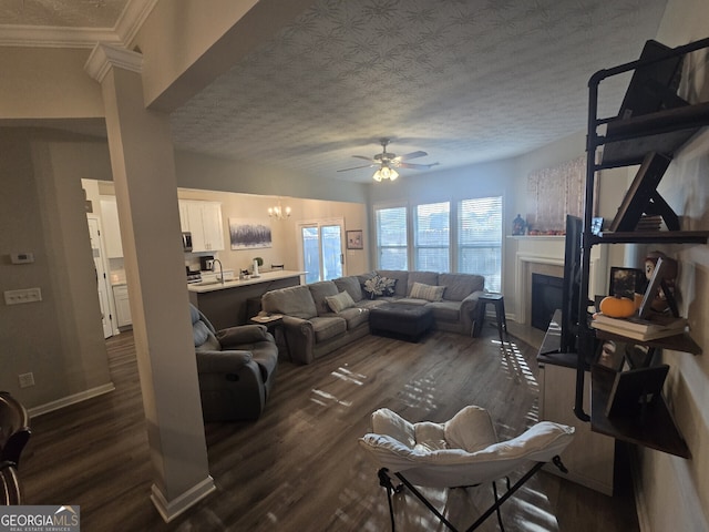 living room featuring a textured ceiling, dark hardwood / wood-style floors, ceiling fan, and sink