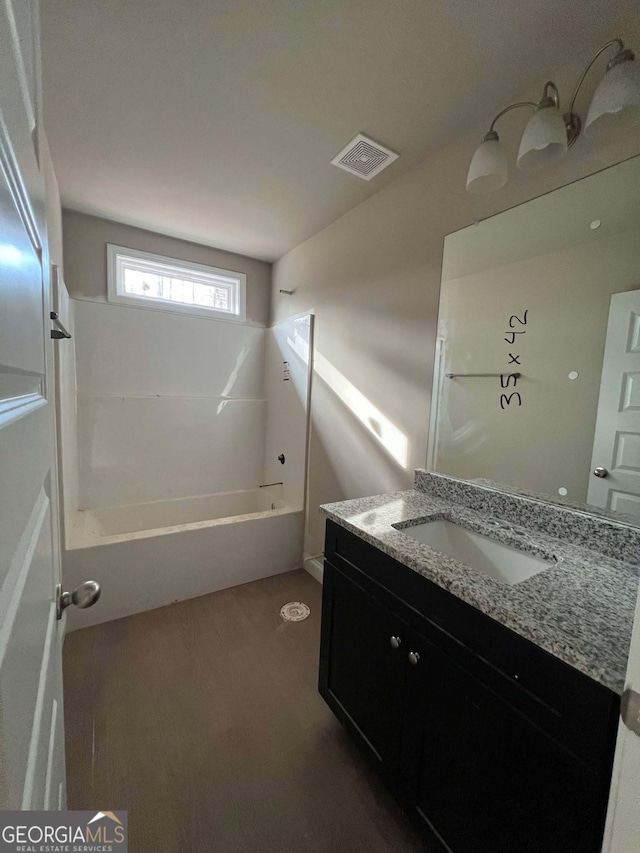 bathroom with shower / bathing tub combination and vanity