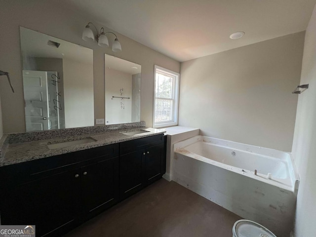 bathroom with vanity and a washtub