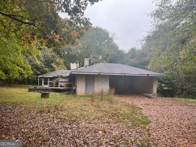 view of side of home with a lawn