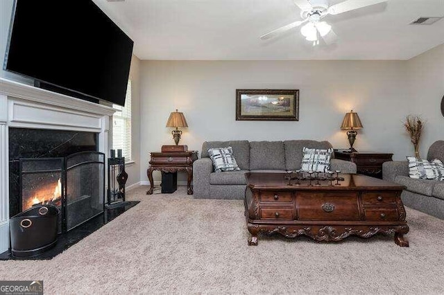 living room featuring light carpet and ceiling fan