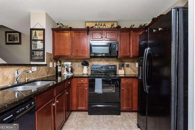 kitchen with sink, tasteful backsplash, dark stone counters, light tile patterned floors, and black appliances