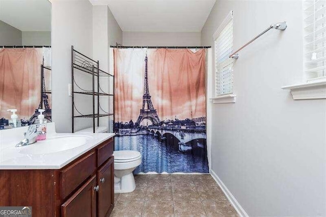 bathroom featuring tile patterned flooring, vanity, and toilet