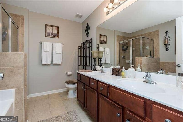 full bathroom with vanity, tile patterned flooring, plus walk in shower, and toilet