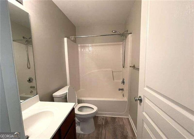 full bathroom with hardwood / wood-style flooring, vanity, toilet, and shower / bath combination