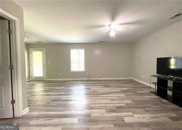 unfurnished living room featuring wood-type flooring