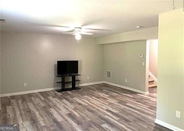 unfurnished living room with dark hardwood / wood-style floors and ceiling fan