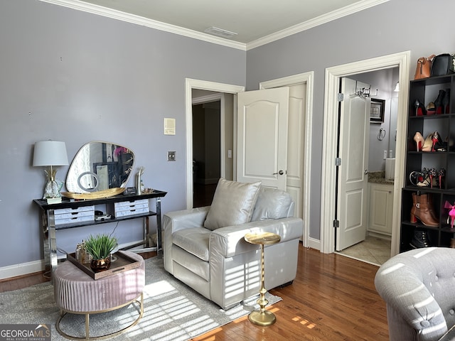 living room with wood-type flooring and ornamental molding