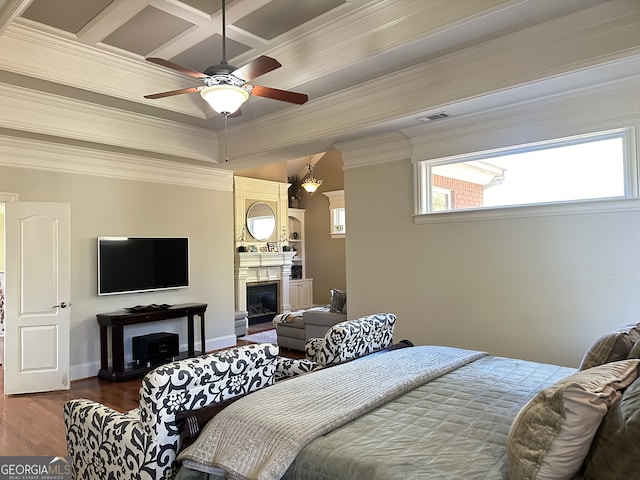 bedroom with beam ceiling, ceiling fan, coffered ceiling, crown molding, and hardwood / wood-style flooring