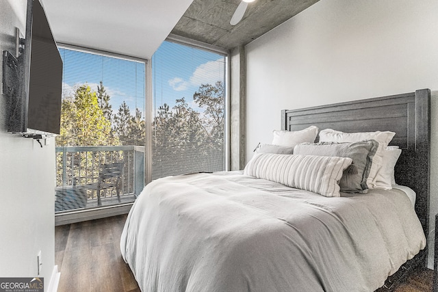 bedroom with multiple windows, ceiling fan, dark hardwood / wood-style flooring, and expansive windows