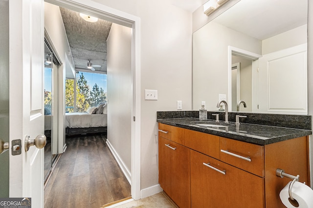 bathroom with ceiling fan, vanity, and hardwood / wood-style flooring