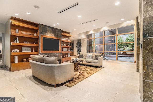 living room with built in shelves and light tile patterned floors