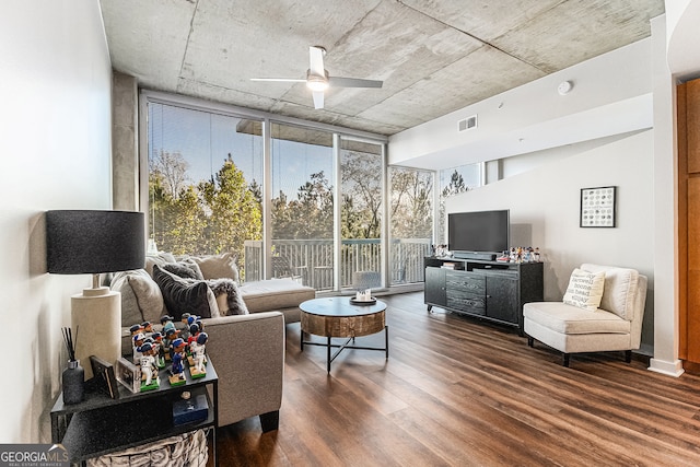 living room featuring ceiling fan, dark wood-type flooring, and a wall of windows