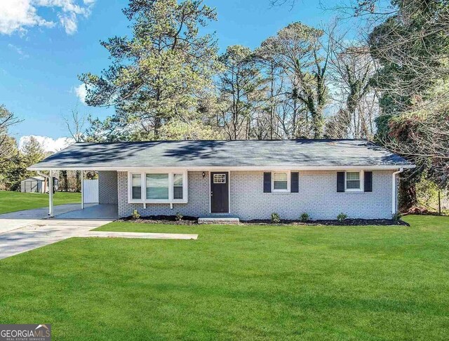 3691 Fred Walker Dr SW, Smyrna, GA 30082 - single story home with concrete driveway, a front lawn, brick siding, and an attached carport