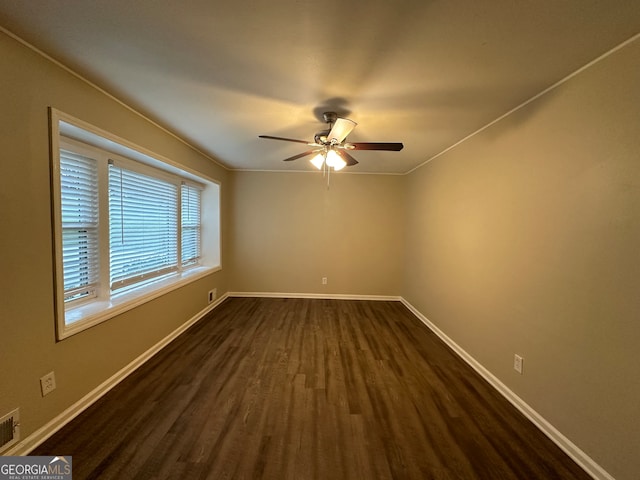 unfurnished room with dark hardwood / wood-style floors, ceiling fan, and ornamental molding