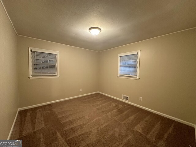 3691 Fred Walker Dr SW, Smyrna, GA 30082 - spare room with dark colored carpet, baseboards, and a textured ceiling