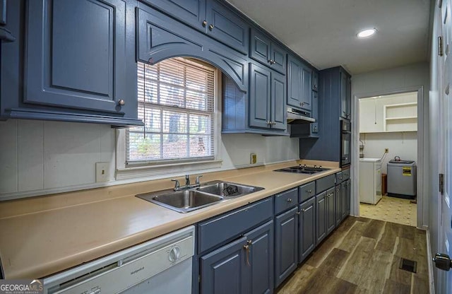 kitchen featuring dishwasher, sink, washing machine and dryer, gas stovetop, and dark hardwood / wood-style flooring