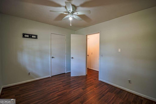 unfurnished bedroom with dark hardwood / wood-style flooring and ceiling fan