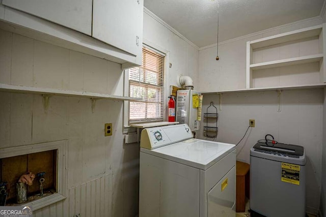 laundry room with washer / clothes dryer, water heater, crown molding, and cabinets