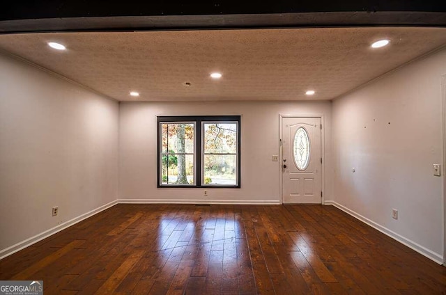 entrance foyer featuring dark hardwood / wood-style floors and a textured ceiling