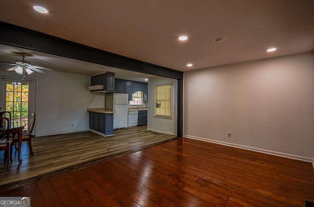 unfurnished living room featuring dark hardwood / wood-style floors and ceiling fan