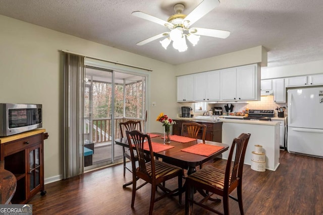 dining space with a textured ceiling, dark hardwood / wood-style flooring, and ceiling fan