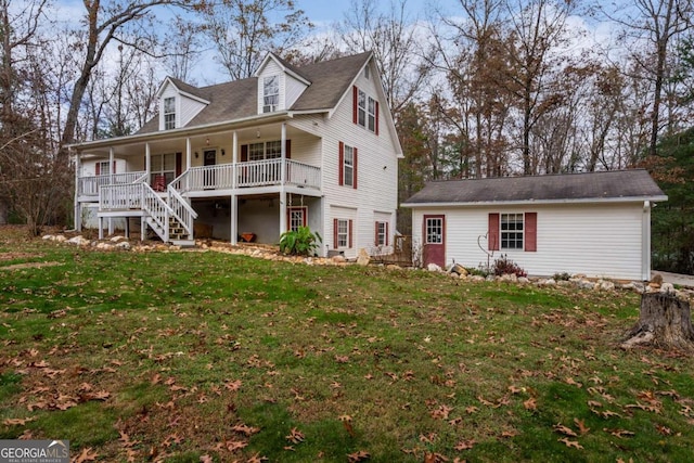 cape cod home featuring a porch, an outbuilding, and a front lawn