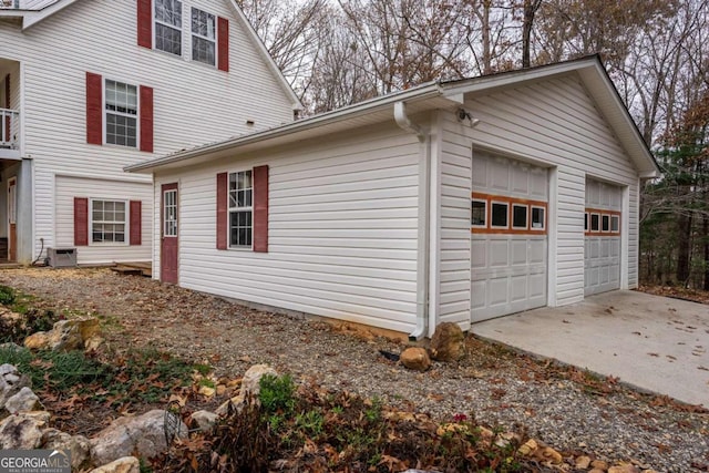 view of home's exterior featuring central AC unit and a garage