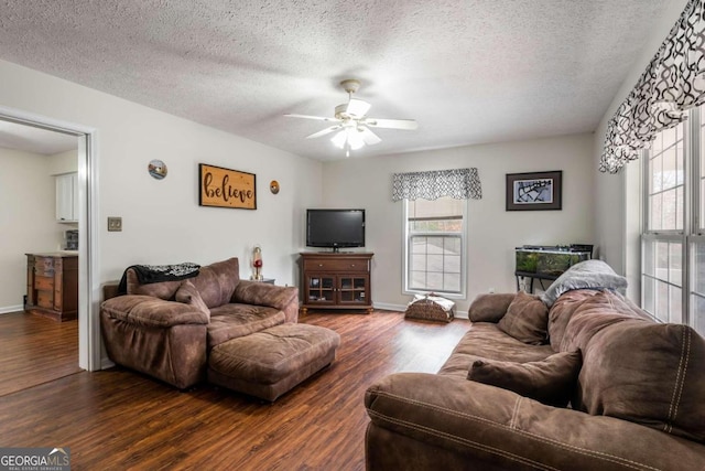 living room featuring a textured ceiling, dark hardwood / wood-style floors, and ceiling fan