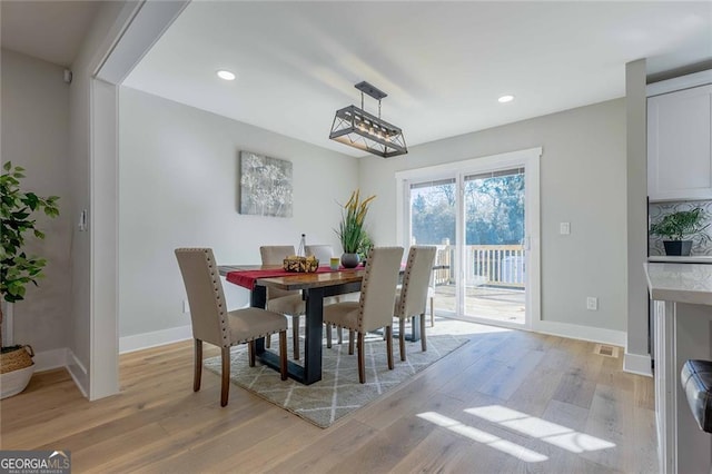 dining area featuring light wood-type flooring